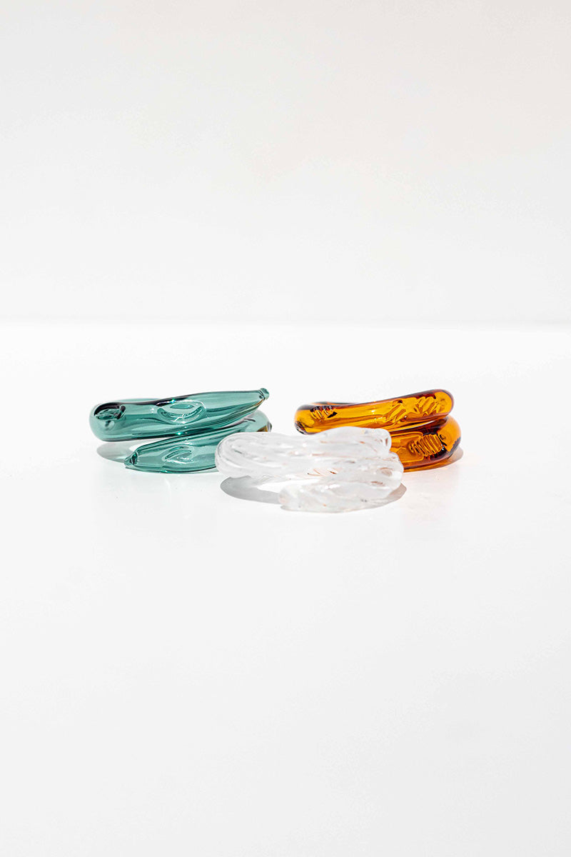 Set of three SALVÁREA rings featuring turquoise, amber, and white Remolino designs, displayed on a neutral background.