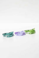 Set of three Salvárea rings featuring turquoise, green, and lilac colors with intricate remolino designs.