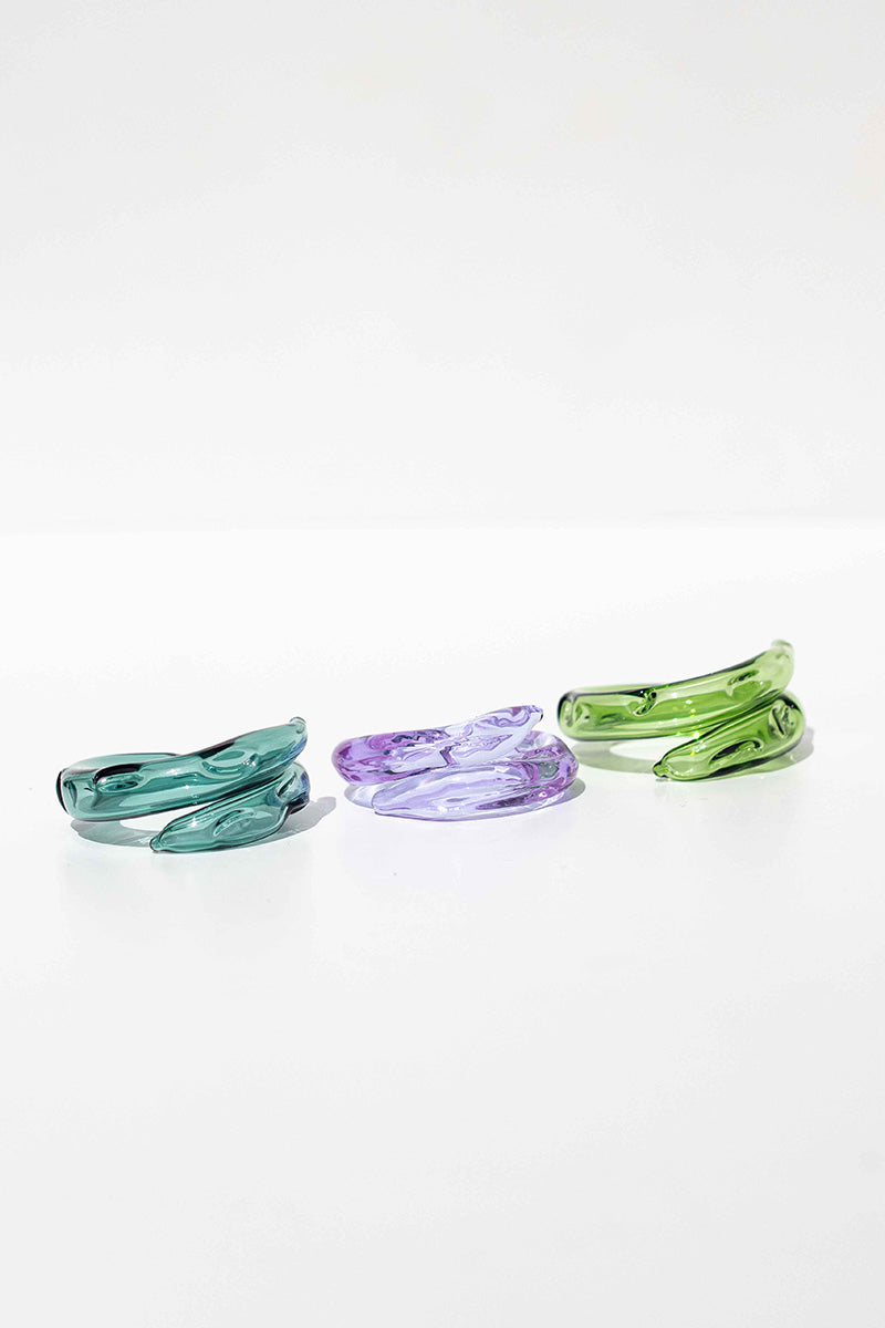 Set of three Salvárea rings featuring turquoise, green, and lilac colors with intricate remolino designs.