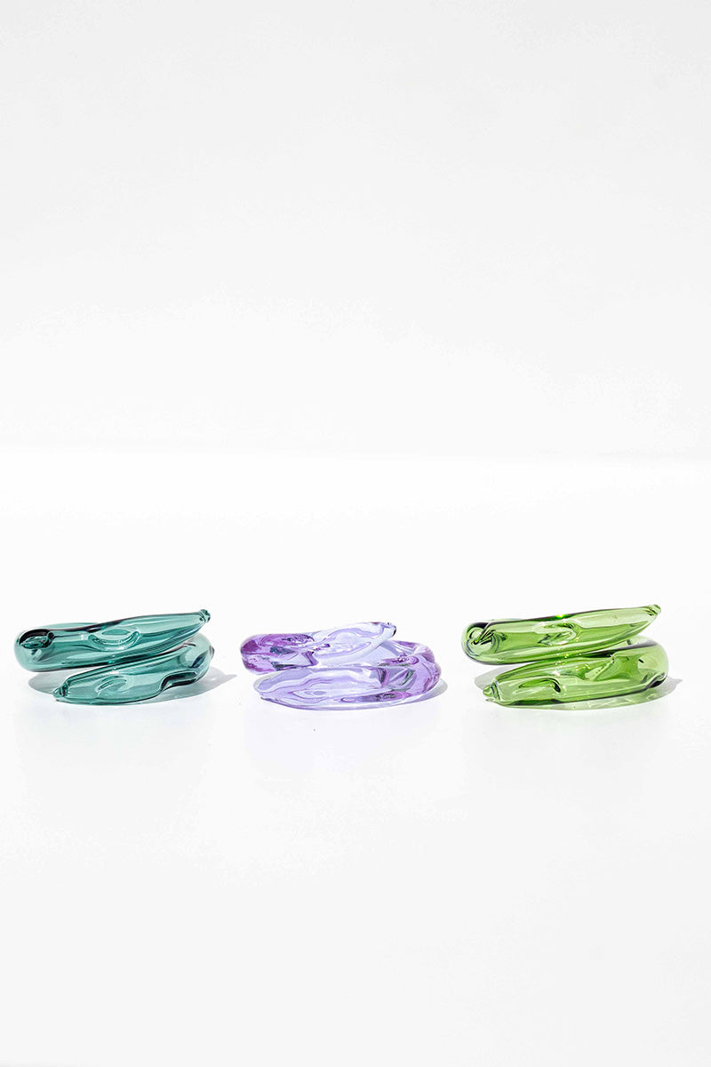 Set of three SALVÁREA rings featuring turquoise, green, and lilac colors, showcasing stylish and colorful ring designs.