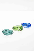 Set of three SALVÁREA rings featuring turquoise, green, and ocean blue colors with swirling remolino designs.