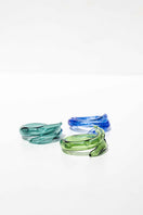 Set of three SALVÁREA rings featuring turquoise, green, and ocean blue colors with intricate remolino designs.