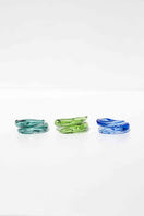 Set of three SALVÁREA rings featuring turquoise, green, and ocean blue colors, showcasing stylish, colorful jewelry designs.