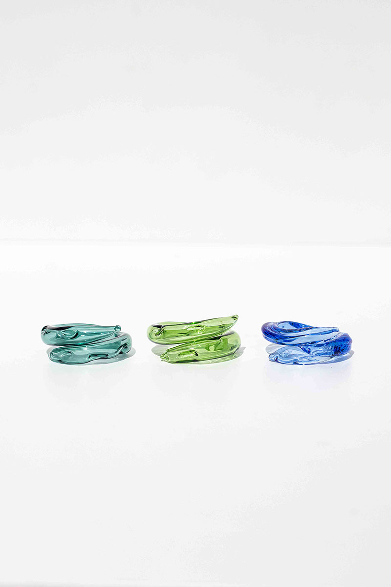 Set of three SALVÁREA rings featuring turquoise, green, and ocean blue colors, showcasing stylish, colorful jewelry designs.