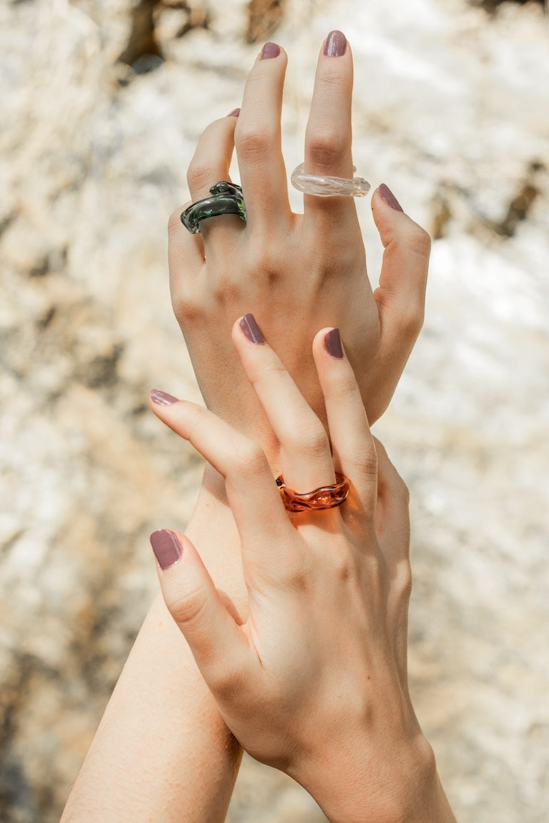 Set of three Salvárea rings featuring turquoise, amber, and white designs, showcasing vibrant colors and intricate patterns.