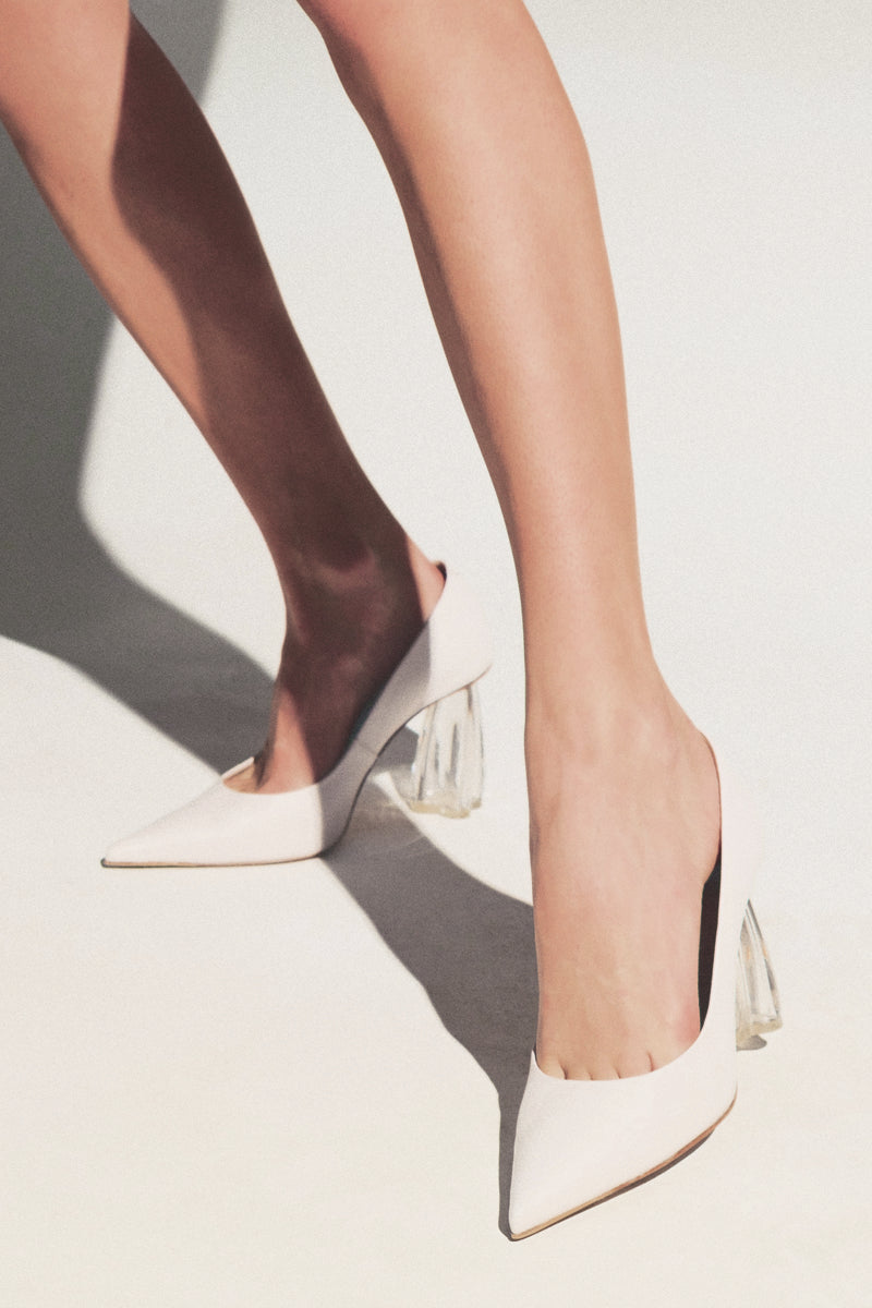 White Fiorellini glass pump heels by House of Atana showing sleek design and transparent heel detail.