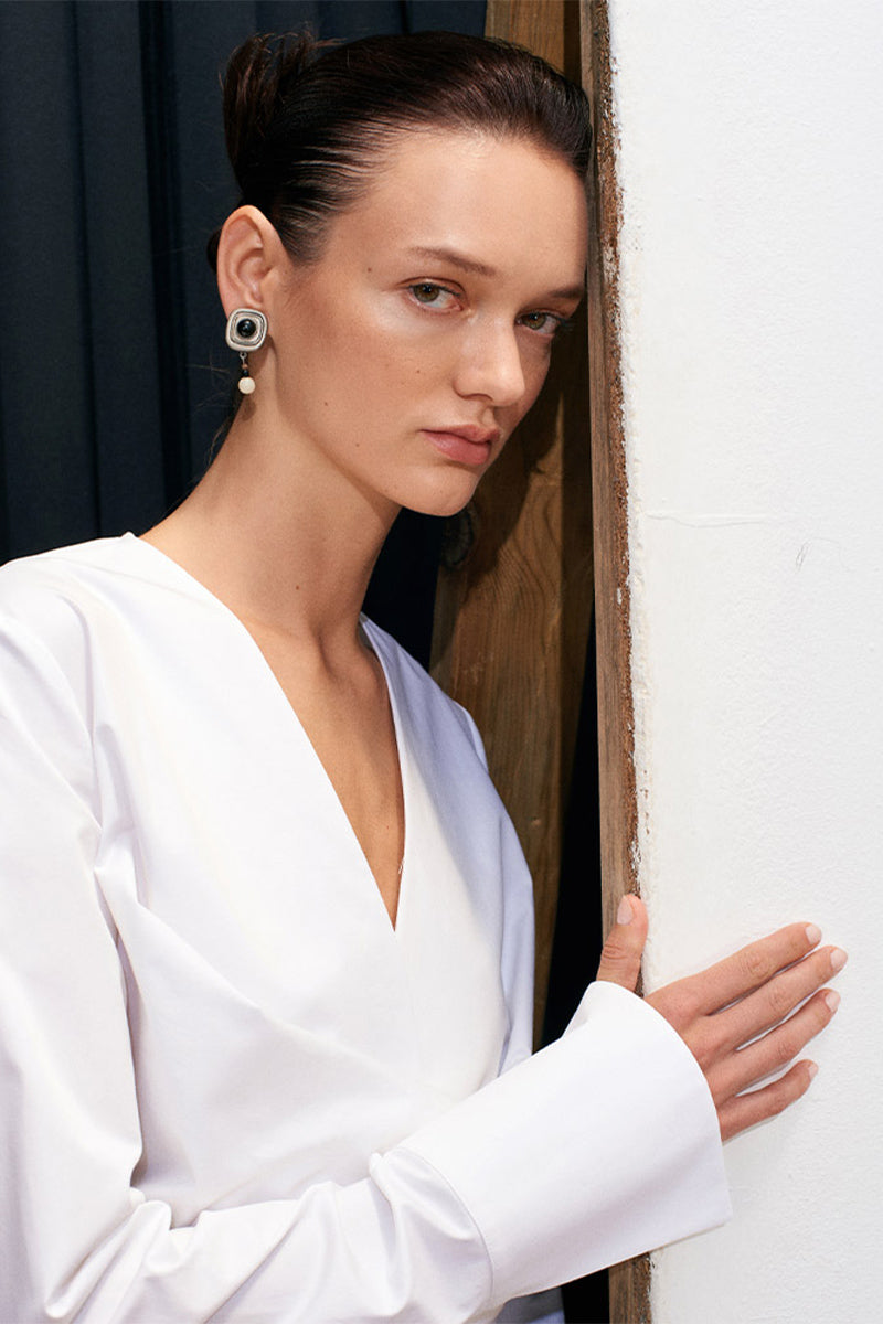 White Journey shirt by Acaria Studio featuring a classic button-up design and tailored fit, shown on a model.