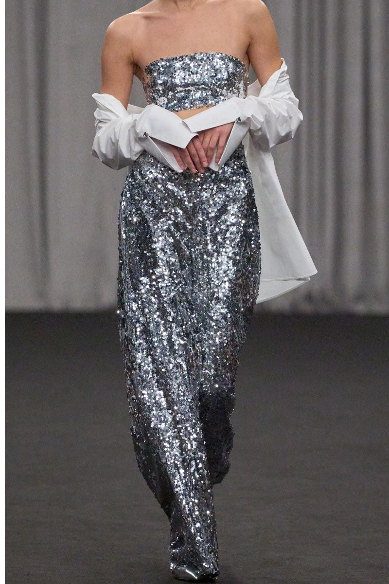Lili Blanc sequin high-waist trousers featuring a fitted silhouette and shimmering sequin fabric for a stylish look.