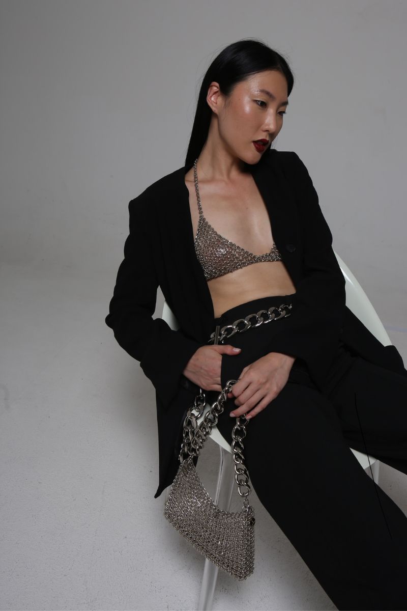 Silvia Gnecchi Chain Bra top featuring a metallic chain design, sleeveless style, and fitted silhouette, perfect for trendy fashion.