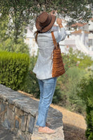 Tan leather shoulder bag by Adriana Castro from the La Red Leather collection, featuring a sleek design and structured silhouette.