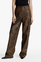 Acaria Studio root washed leather pants showing a close-up of soft, textured, dark leather fabric and tailored fit.