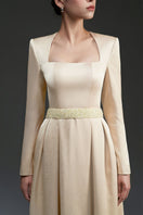 Elegant gold silk taffeta gown by I.H.F Studio, showcasing flowing fabric and intricate design details.