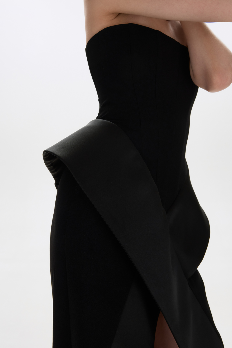 Black Nora gown by Balykina, elegant floor-length dress with flowing fabric and fitted waist for formal occasions.