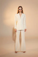 Nazlı Ceren Marylebone crepe flared trousers in vanilla ice, showcasing the high-waisted, wide-leg design and smooth fabric detail.