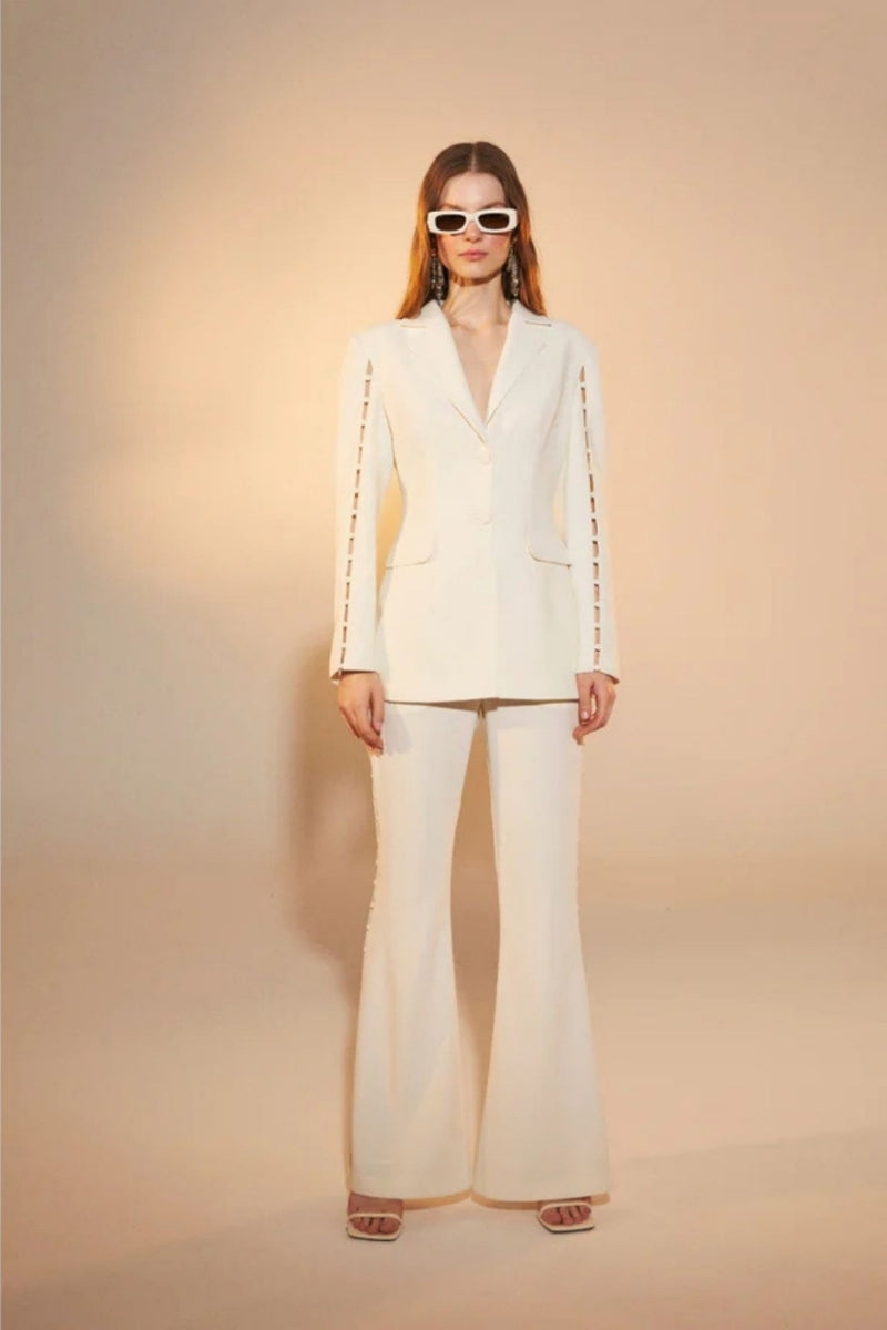 Nazlı Ceren Marylebone crepe flared trousers in vanilla ice, showcasing the high-waisted, wide-leg design and smooth fabric detail.