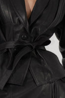 Black Damien leather jacket by Double A, featuring sleek design and classic leather texture, displayed on a hanger.