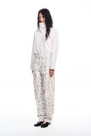 Chictopia floral jeans showing vibrant floral pattern, slim fit design, and denim material on a model.