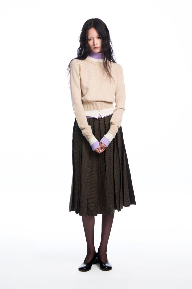 Chictopia layered beige cashmere sweater with a cozy, textured design, perfect for stylish winter or fall outfits.