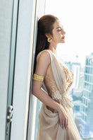 Elegant nude silk evening gown by Do Long, featuring a flowing 3/4 length design and sophisticated style.