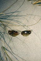 Moy Atelier Poisoned Apples Forget Me Not sunglasses with colorful apple-inspired frames and tinted lenses.