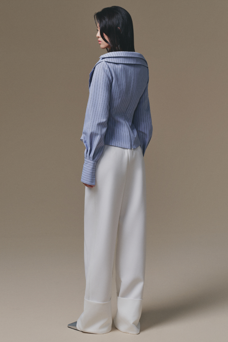 Blue Selena shirt by Keira Tong featuring a relaxed fit, collar, and button-down front, displayed on a hanger.