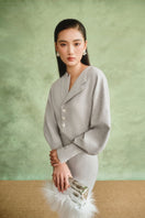 Gray sculptural maxi dress by White Plan, flowing fabric with a modern, artistic design, shown on a model.