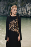 Black velvet satin boat neck gown by Lune De Soie with long sleeves and elegant drape, perfect for formal occasions.