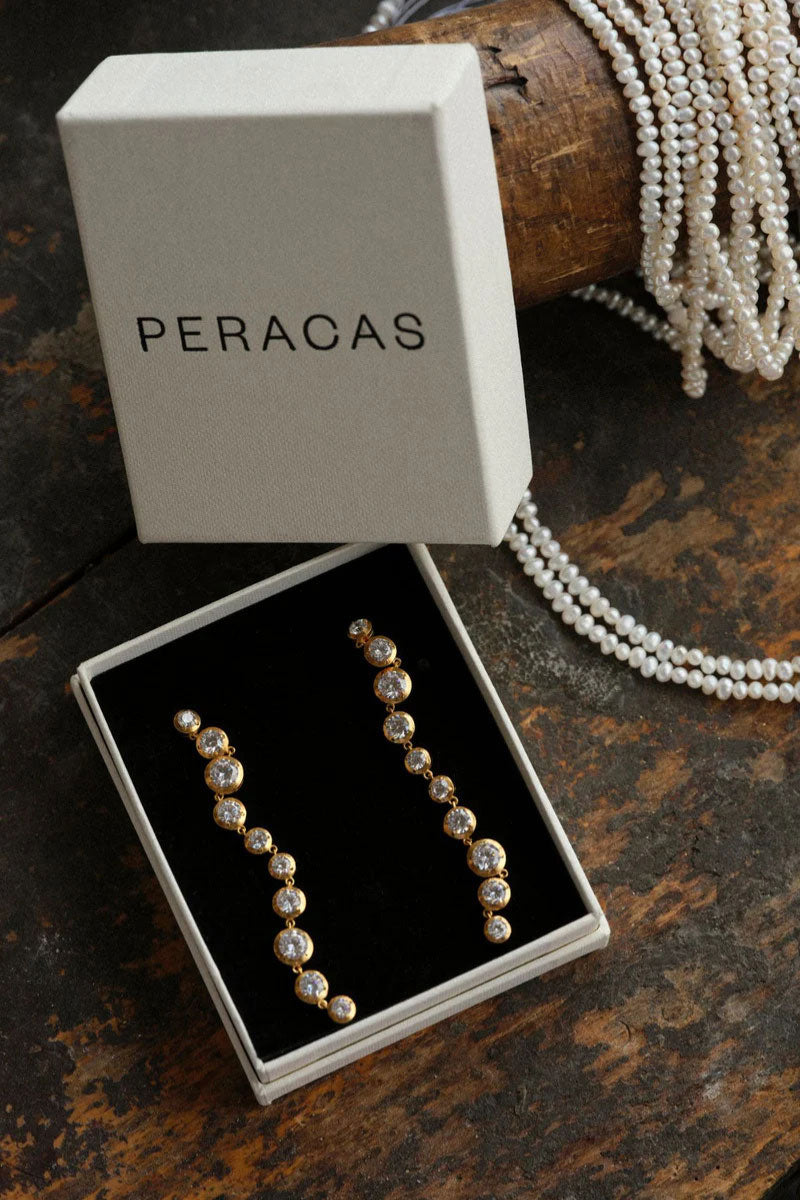 Peracas Bella earrings in white with elegant drop design, showcasing a stylish and sophisticated jewelry accessory.