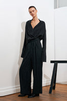 Black and white striped harem pants by Acaria Studio, featuring a relaxed fit and comfortable waistband.