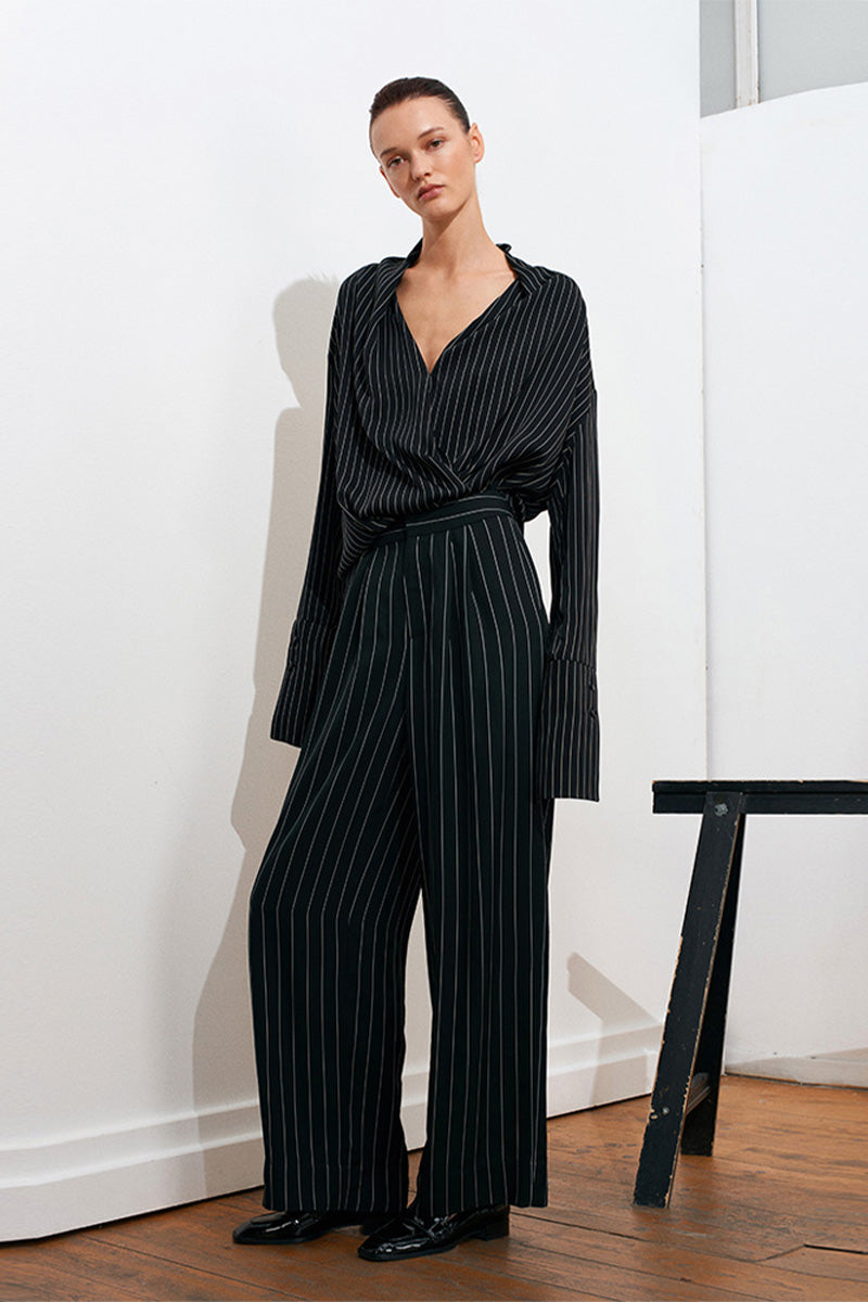 Black and white striped harem pants by Acaria Studio, featuring a relaxed fit and comfortable waistband.