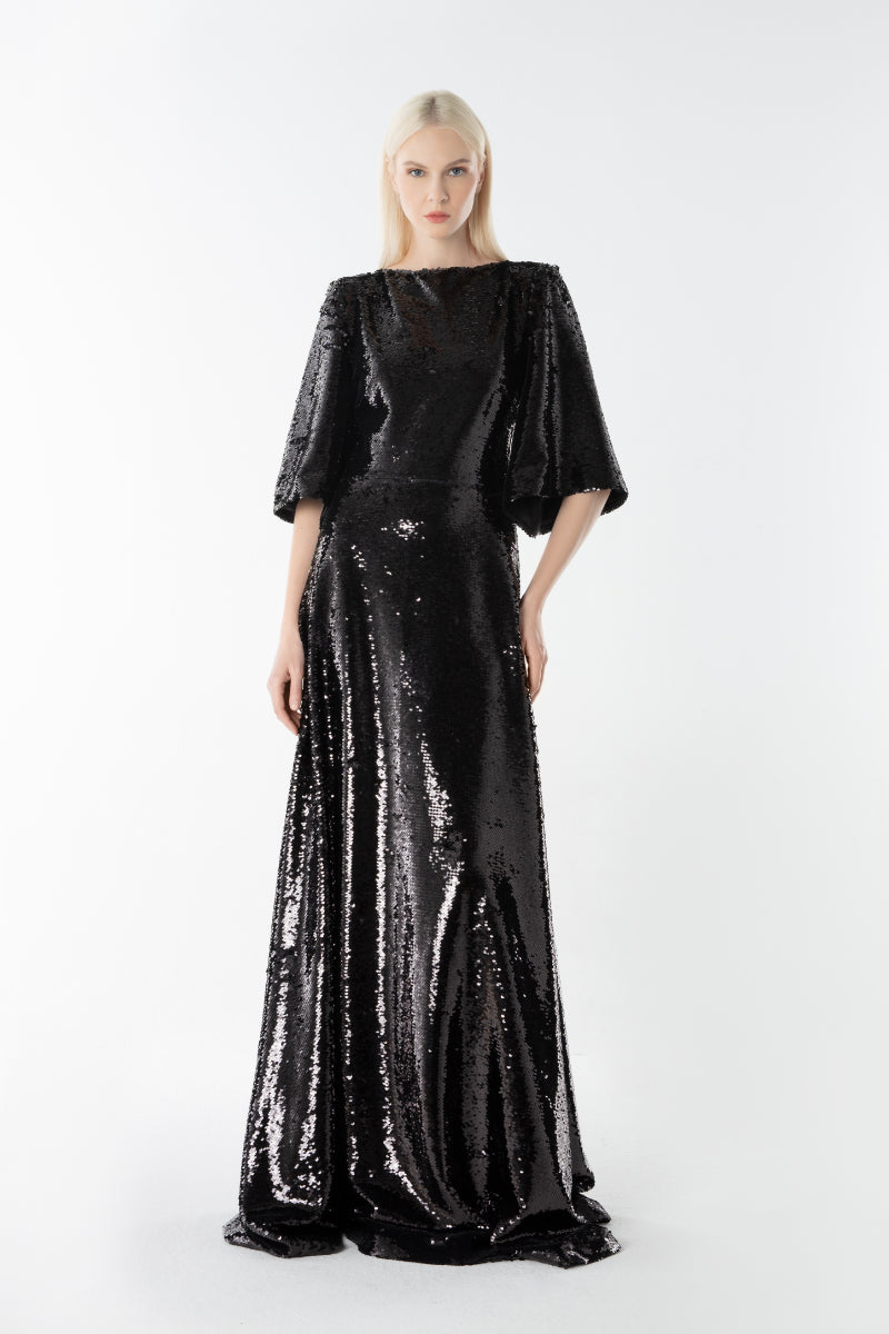 Lili Blanc Glow Gown, elegant floor-length gown with flowy fabric and subtle shimmer, perfect for formal occasions.