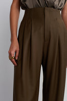 Dark brown Earth Pants by Acaria Studio, featuring a relaxed fit and earthy fabric, displayed on a neutral background.
