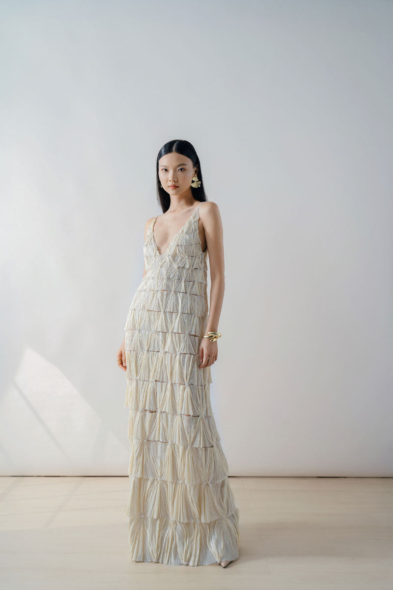 Beige deep V-neck tiered pleated maxi dress by DOC BAN displayed on model, flowing fabric and elegant design.