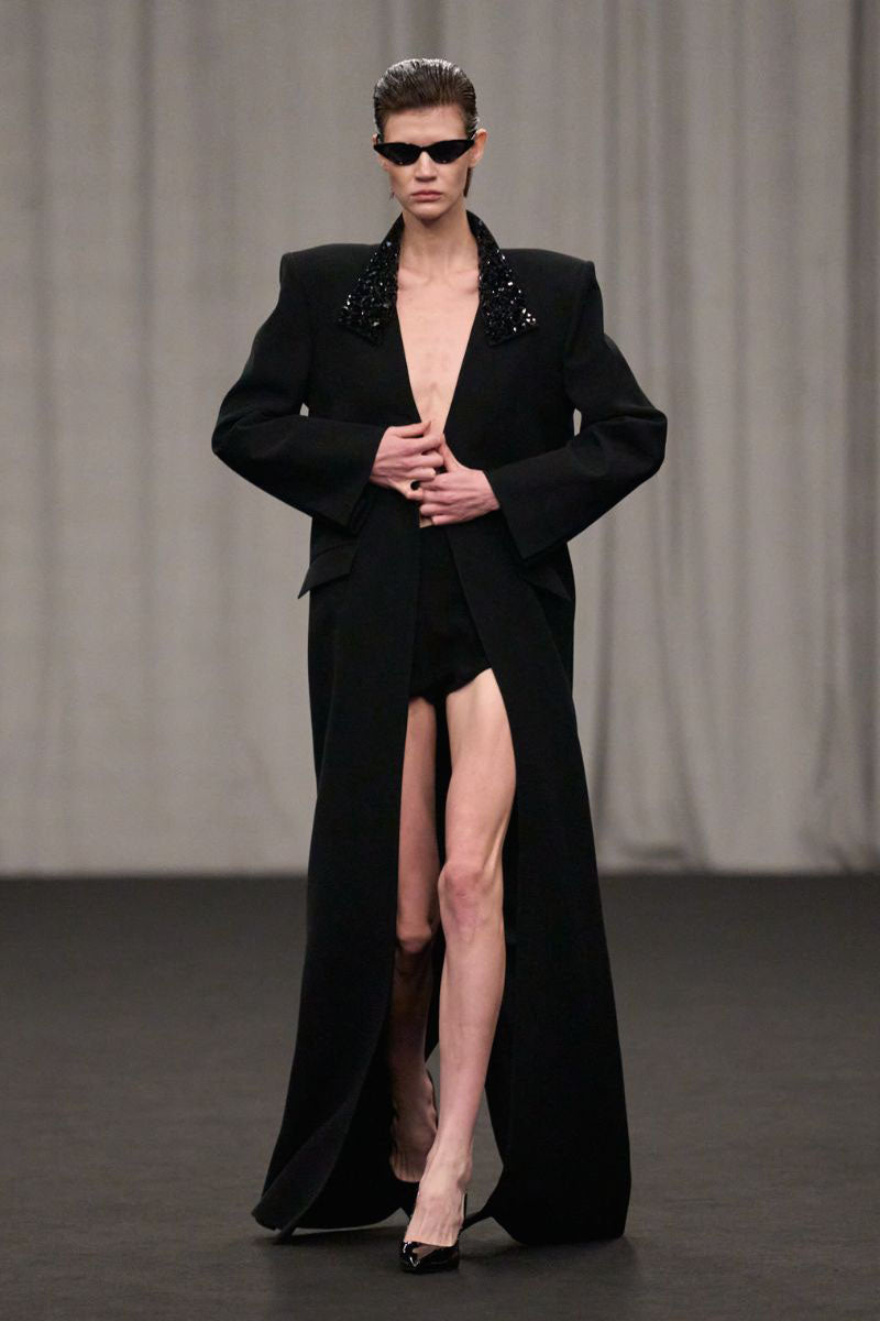 Lili Blanc oversized tailored coat with wide lapels and structured fit, shown in a neutral color on a model.