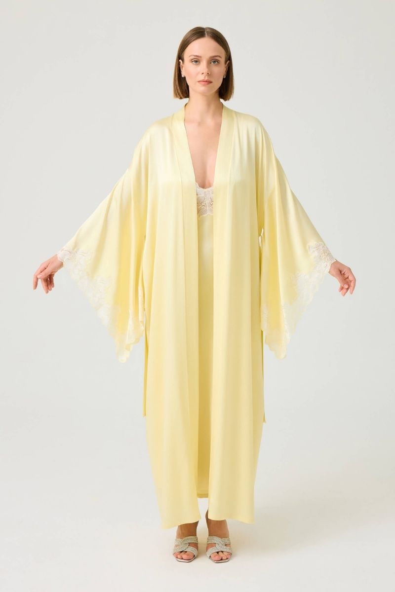 Heidi long rayon robe by Bocan Couture with butter yellow lace accents and flowing fabric, displayed on a hanger.