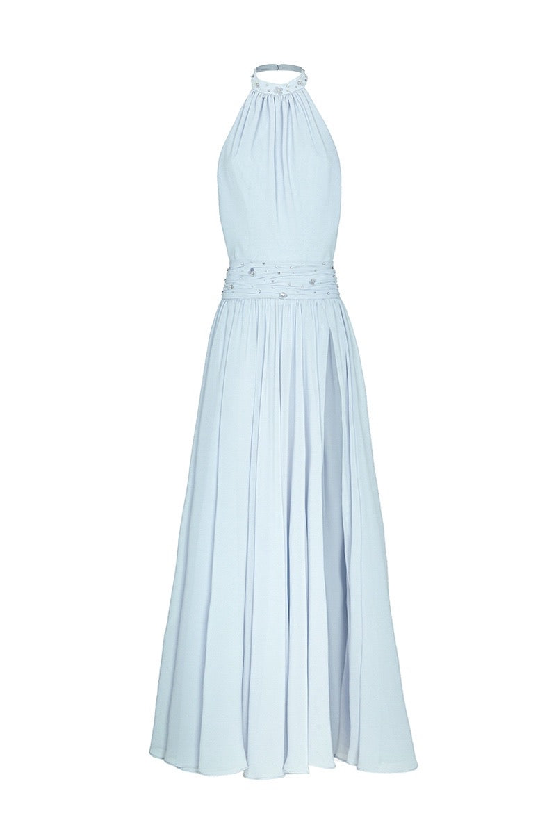 Powder blue embroidered gown by Monika Dimova displayed on a hanger with intricate embroidery details and flowing fabric.