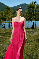 Le Thanh Hoa pink off-shoulder pleated gown with flowing fabric and elegant design, perfect for formal occasions.