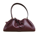 Rose de Mai Arabesque bucket bag in burgundy with shoulder strap, soft leather design, and stylish details.