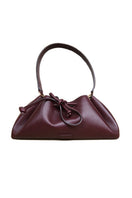 Rose de Mai Arabesque bucket bag in burgundy with shoulder strap, soft leather design, and stylish details.