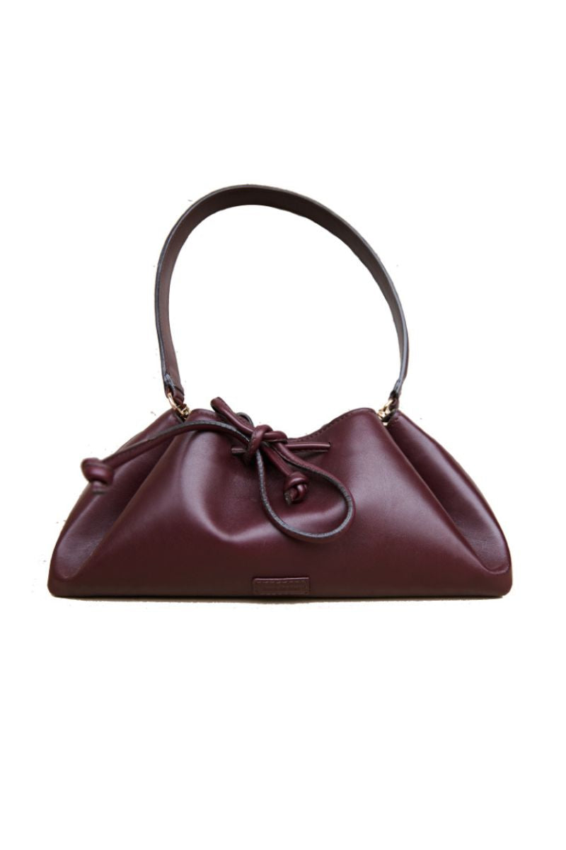 Rose de Mai Arabesque bucket bag in burgundy with shoulder strap, soft leather design, and stylish details.