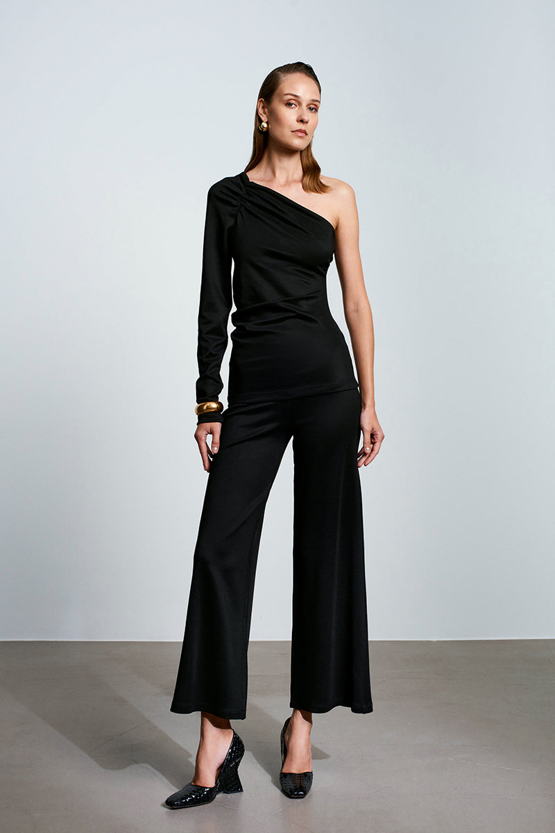 Black tops by Acaria Studio featuring the Umbra Top design, shown on a model with a stylish, modern look.