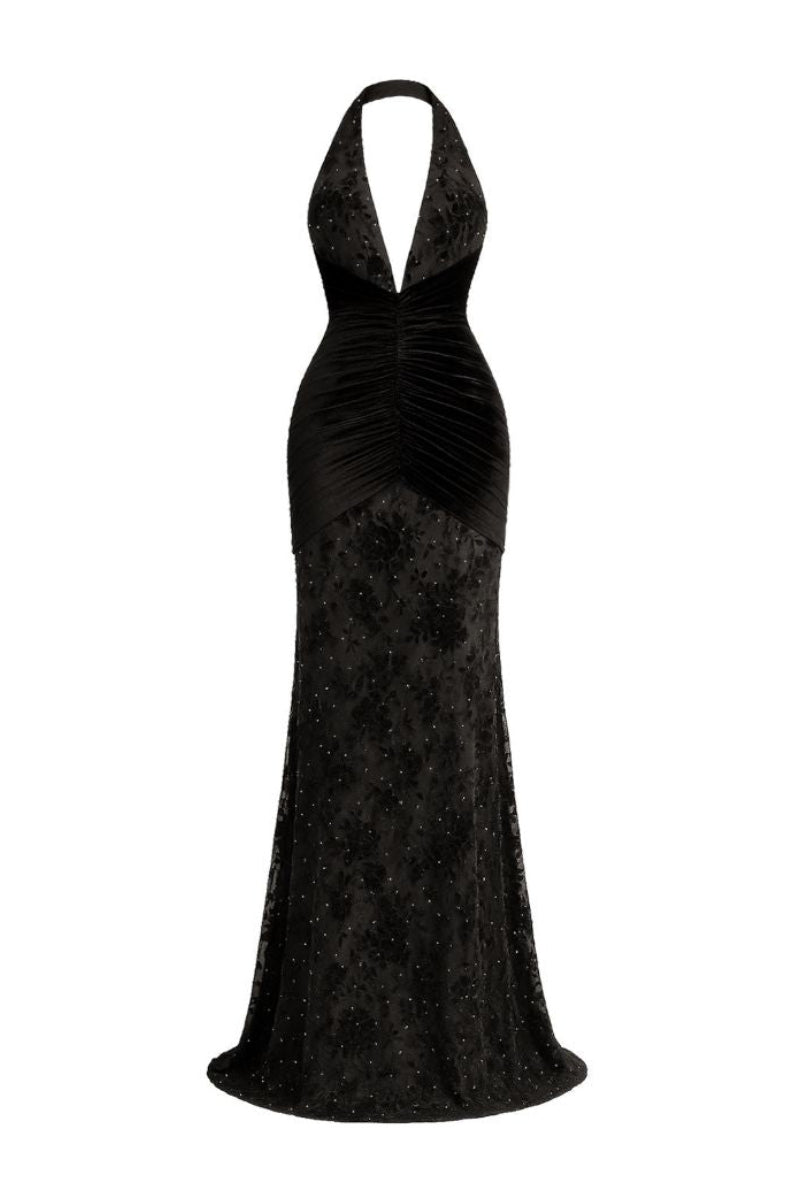 Black KAYLIN maxi dress by Khanum's, flowing fabric and elegant design, shown on a model standing outdoors.