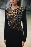Black velvet satin gown by Lune De Soie with floral embellishments and elegant design, perfect for formal occasions.