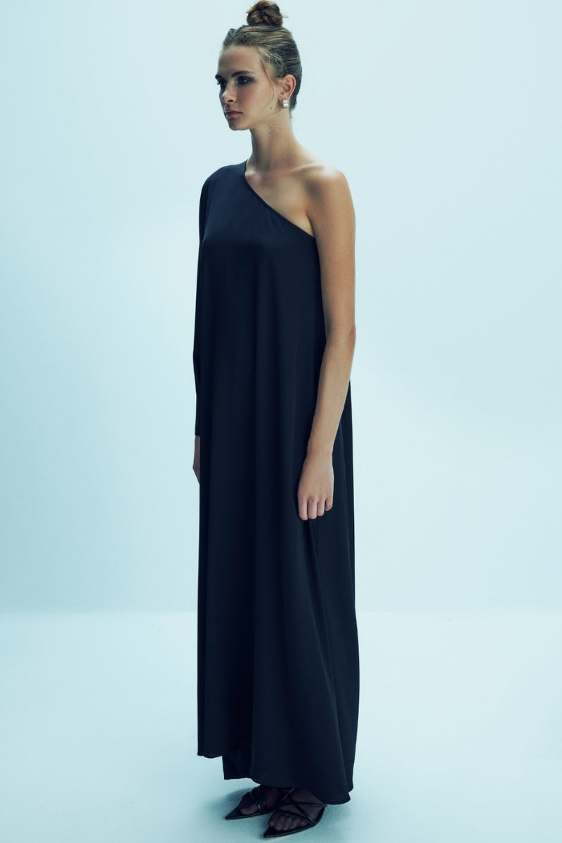 Black Venus one-shoulder satin maxi dress by Nazlı Ceren, flowing fabric with elegant drape and stylish asymmetrical neckline.