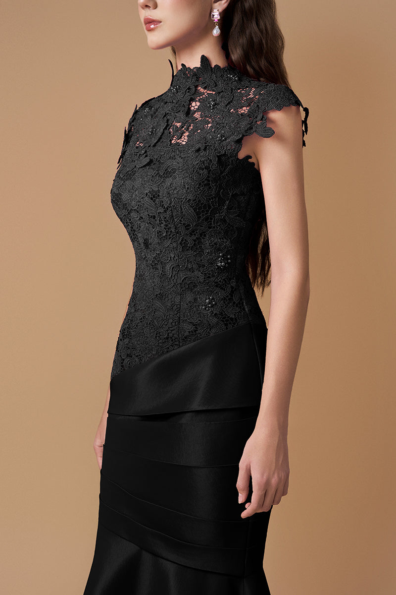 Elegant black gown with guipure lace and taffeta silk lining, designed by I.H.F, featuring intricate lace details and a flowing silhouette.