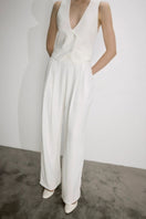 White Tina trousers with satin waistband by Nazlı Ceren, stylish pants featuring a sleek satin detail at the waist.