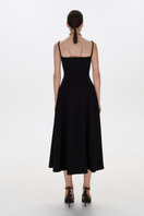 Black BALYKINA midi dress with adjustable straps, stylish sleeveless design, shown on a model.