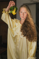 Brown silk custom gown robe from Not Just Pajama, featuring smooth fabric and a relaxed fit, shown laid flat.