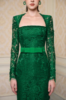 Green I.H.F trapeze long sleeve gown with a flowing silhouette and elegant design, perfect for formal occasions.