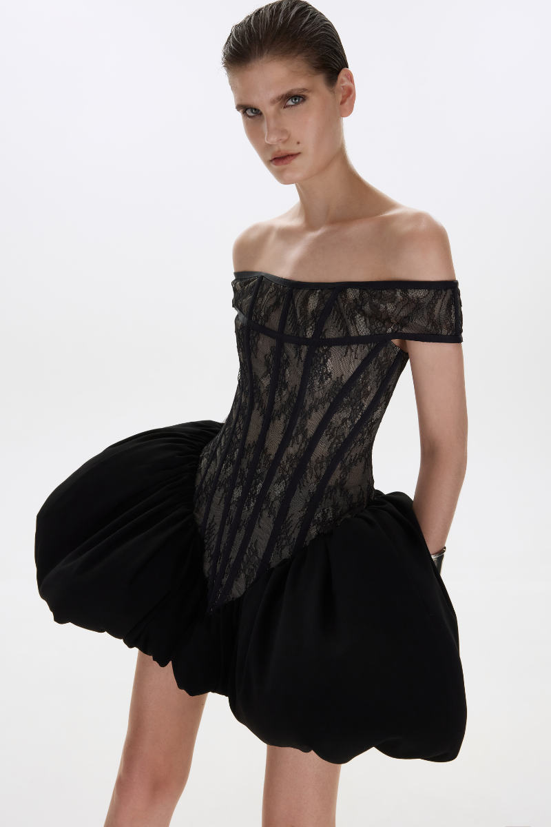 Black THEA mini dress by BALYKINA, showcasing a stylish, fitted design with elegant details in a close-up image.
